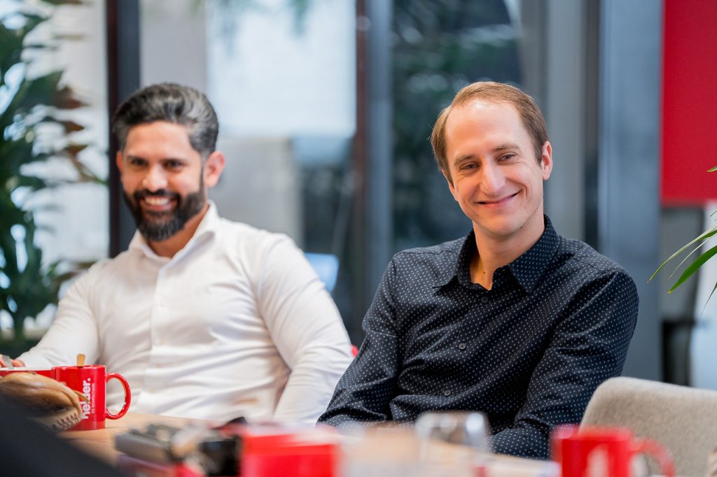 Onze medewerkers Omid Sabet en Laurens Stam lachend aan tafel